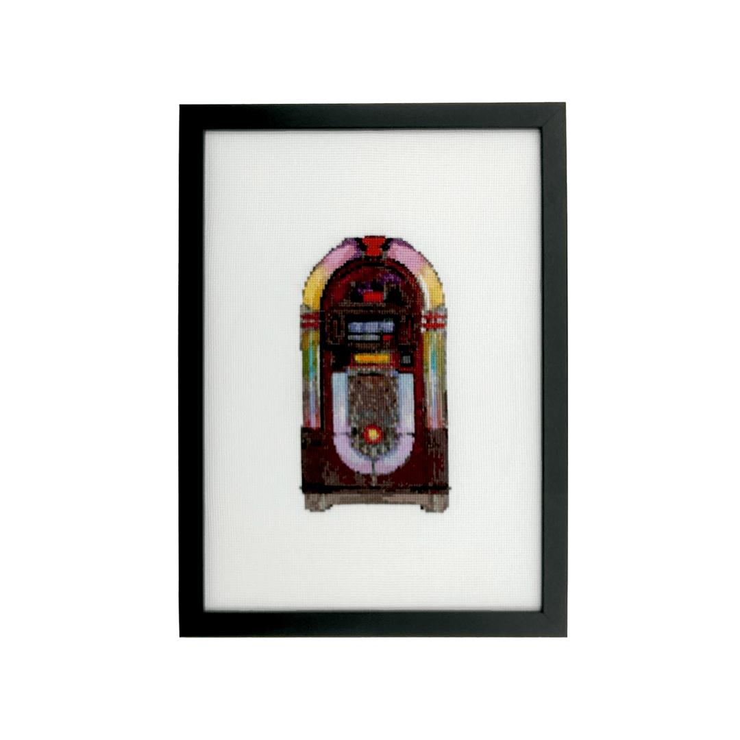 wurlitzer jukebox hand stitched on white aida fabric in a black frame