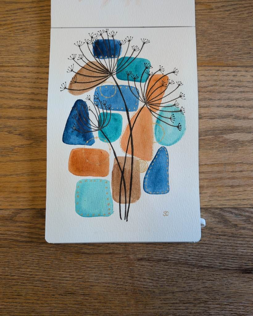 This is a mixed media watercolor painting with ink in portrait orientation in an A5 sketchbook. The background is made up of watercolor shapes in blue, aqua, orange, and brown. On top of the background are 3 stems of a multi branchlet with little dried seeds at each mini branchlet in black ink. Finally there is gold detailing around and in-between some of the watercolor shapes.