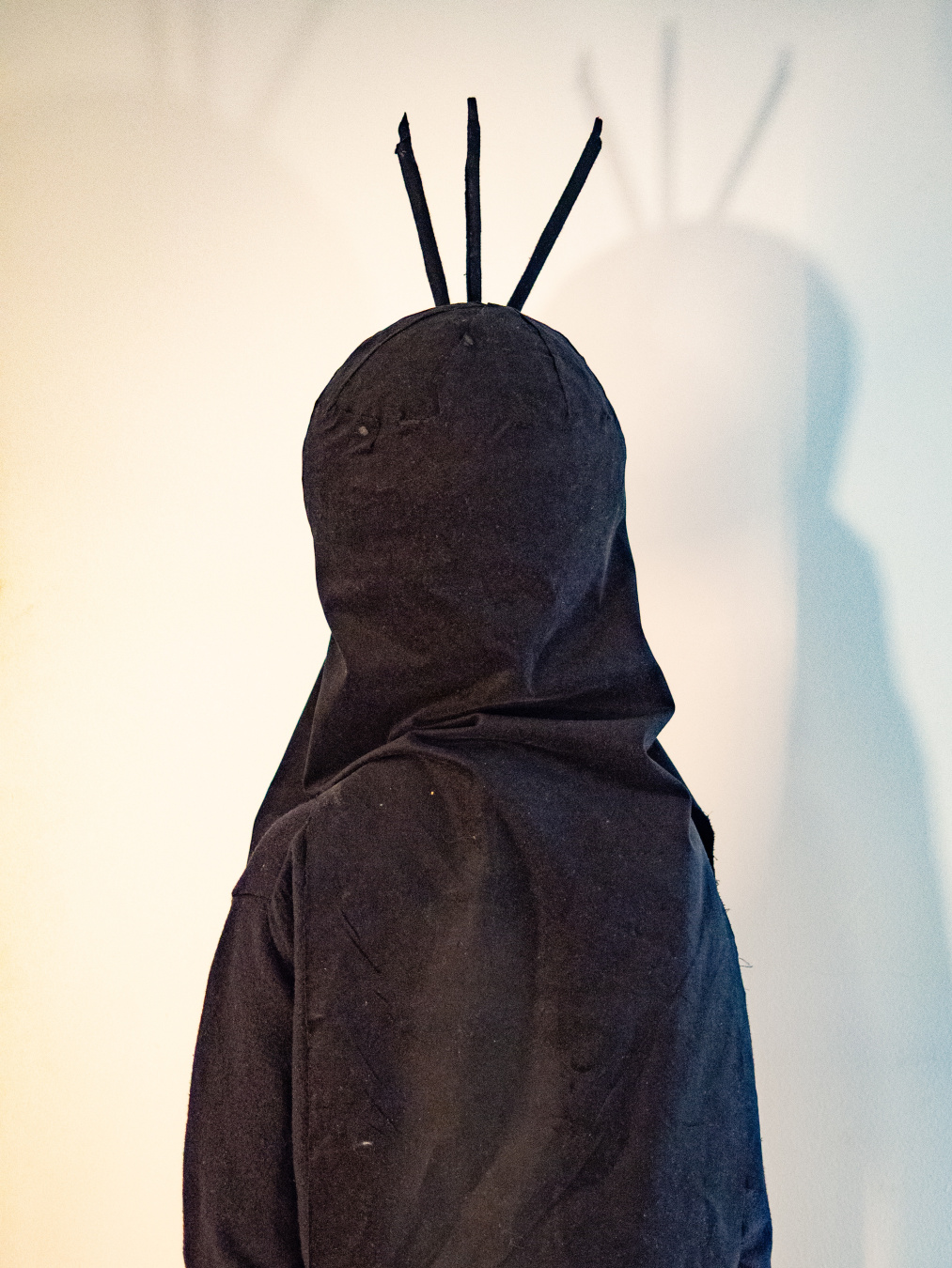 Kid in carnival costume of the little mole facing backward