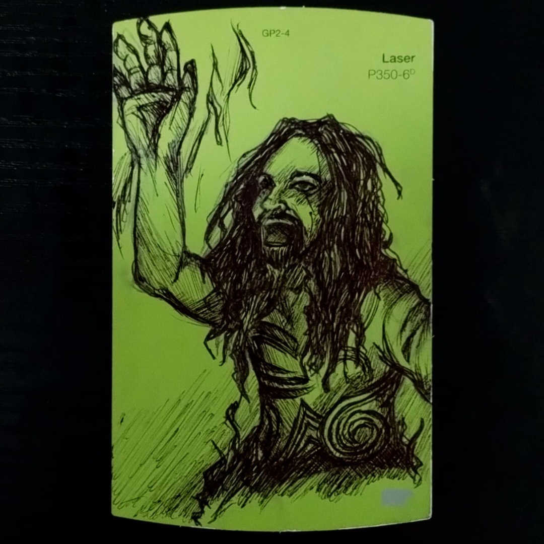 A drawing for the Inktober 2023 art challenge on a bright green Behr brand paint chip.  The prompt is "Spiders".  The sketch is based on a System of a Down music video, titled Spiders.  The drawing is of a costumed Serj Tankian.