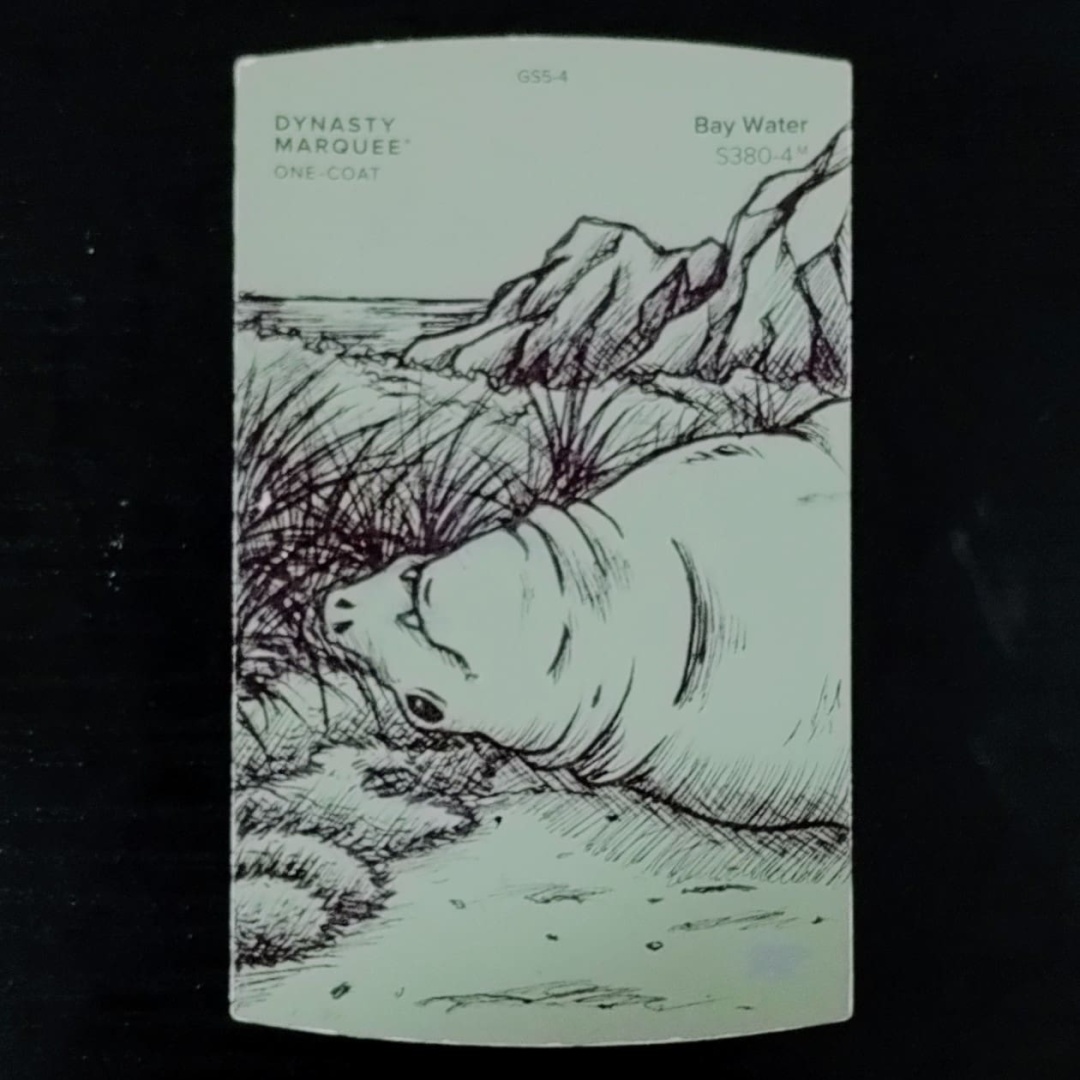 A large elephant seal blocks a path.  The drawing is on a dull green Behr paint color card, the color name is Bay Water.  It is for the Inktober 2023 Day 3 prompt, Path