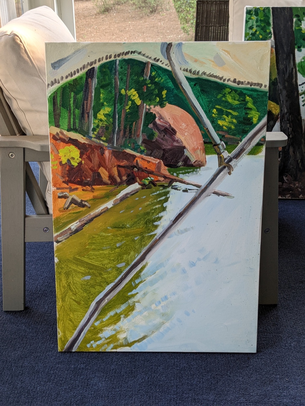 a painting of a large reddish rock in the water, there's orange soil and green trees in the background. the foreground is water with the metal pole of a boat cover in the extreme foreground