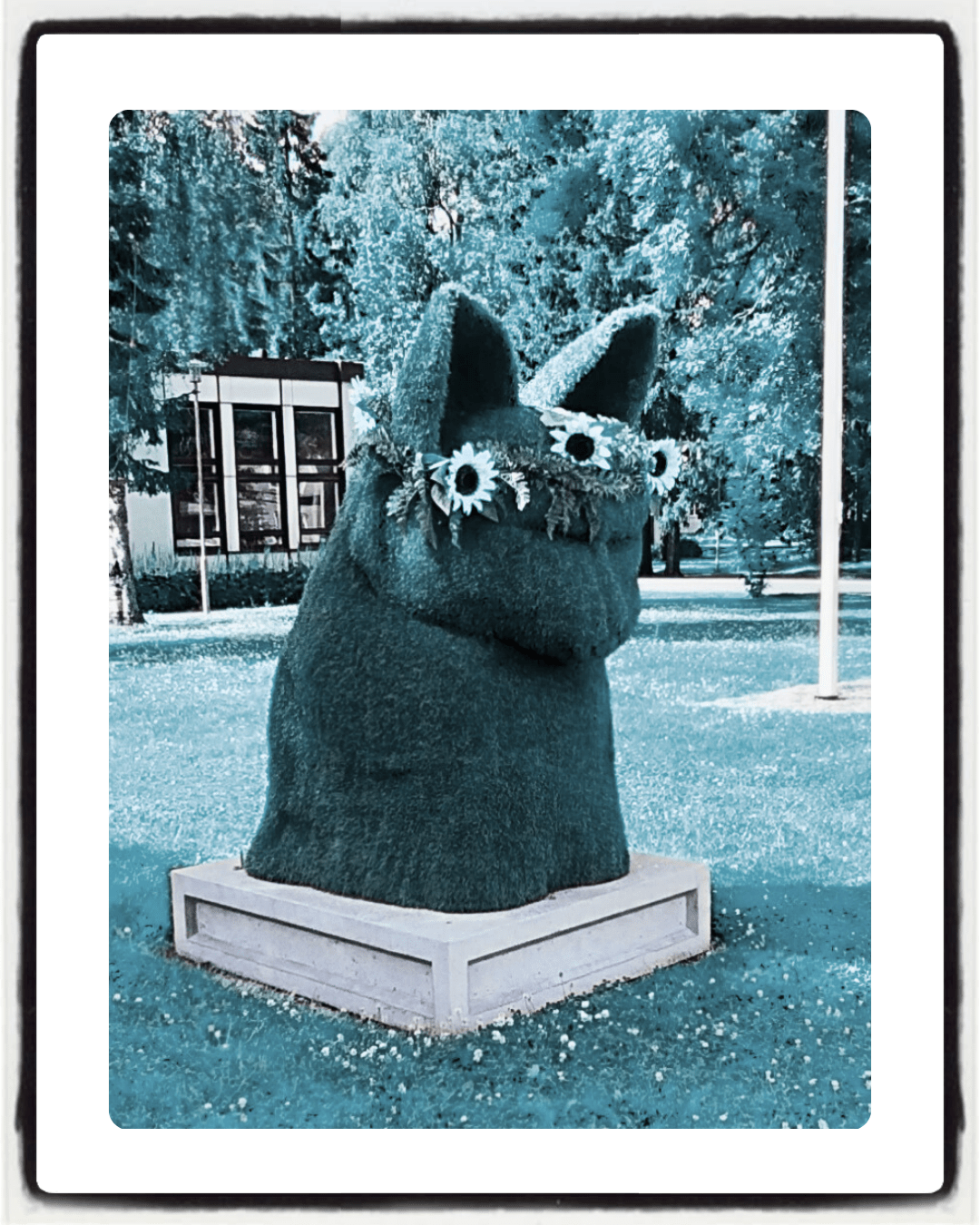 A green sculpture of a cat's head